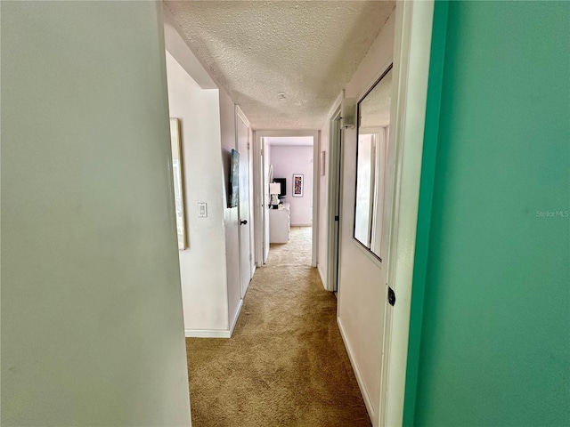 320 Medallion Blvd Unit G, Madeira Beach, FL 33708 - hall with carpet, a textured ceiling, and baseboards