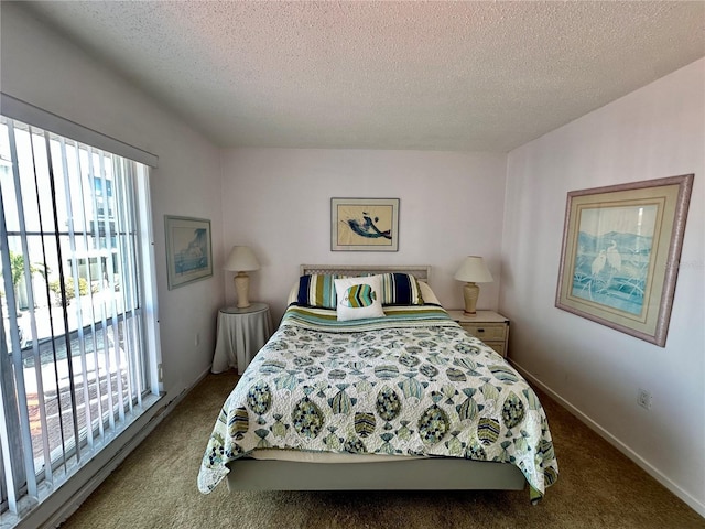 320 Medallion Blvd Unit G, Madeira Beach, FL 33708 - bedroom featuring carpet floors, a textured ceiling, and baseboards