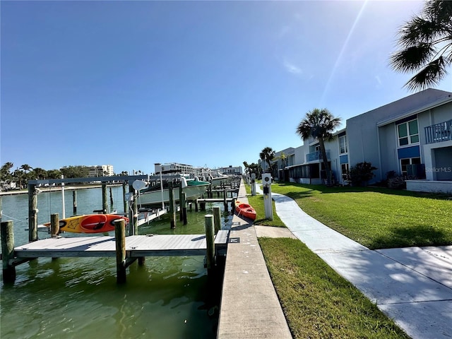 320 Medallion Blvd Unit G, Madeira Beach, FL 33708 - dock area with boat lift, a lawn, and a water view