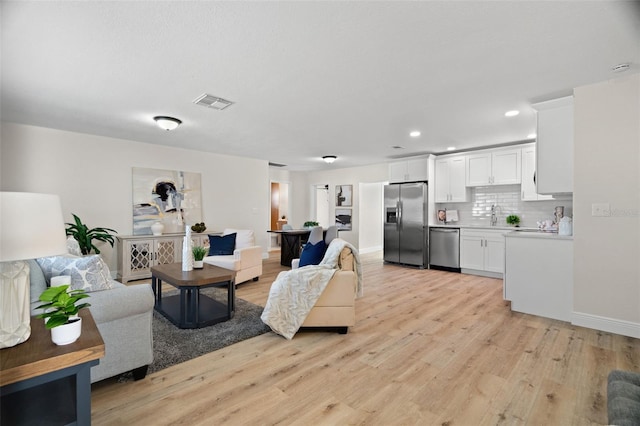 4549 Ontario Dr, New Port Richey, FL 34652 - living area with light wood-style floors, baseboards, and recessed lighting