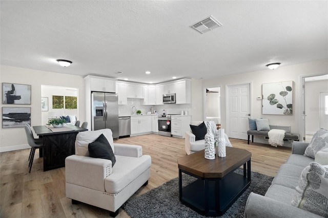 4549 Ontario Dr, New Port Richey, FL 34652 - living area with light wood-style floors, recessed lighting, and baseboards