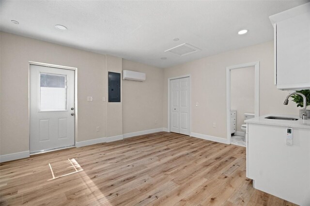 4549 Ontario Dr, New Port Richey, FL 34652 - entrance foyer with electric panel, light wood-type flooring, a wall mounted AC, baseboards, and recessed lighting