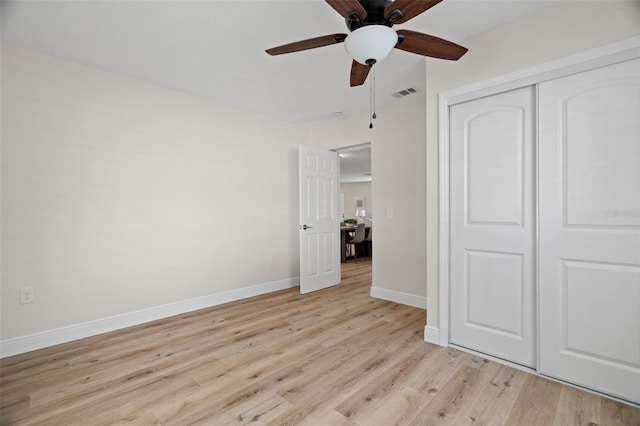 4549 Ontario Dr, New Port Richey, FL 34652 - unfurnished bedroom with light wood-style flooring, a closet, baseboards, and a ceiling fan