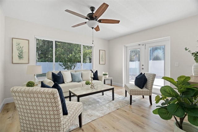 4549 Ontario Dr, New Port Richey, FL 34652 - living room with french doors, plenty of natural light, light wood-style flooring, and ceiling fan