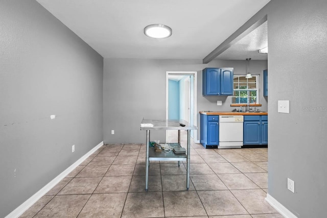 kitchen with blue cabinetry, white dishwasher, wood counters, light tile patterned floors, and baseboards