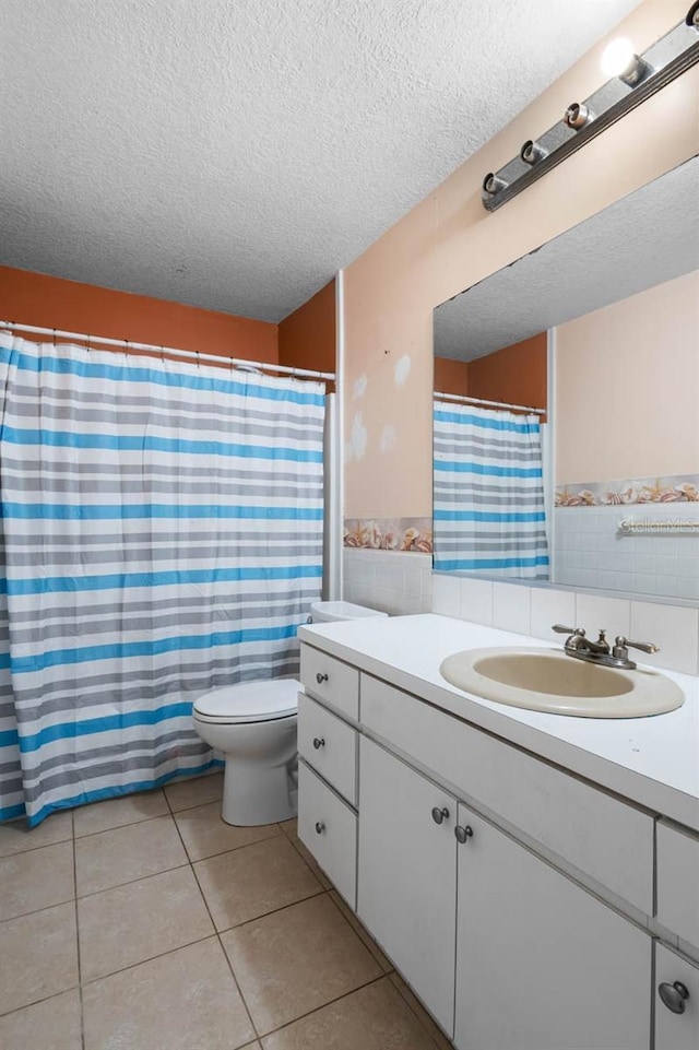 full bath with tile walls, a textured ceiling, tile patterned floors, vanity, and toilet