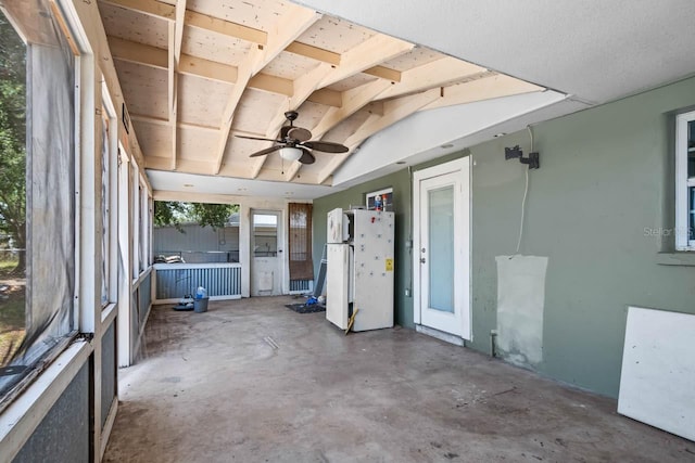 unfurnished sunroom featuring ceiling fan