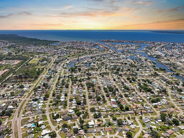 aerial view of property and surrounding area featuring a nearby body of water