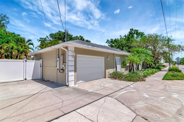 4125 W Obispo St, Tampa, FL 33629 - view of front of home featuring a gate, concrete driveway, stucco siding, fence, and a garage