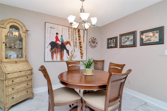 4125 W Obispo St, Tampa, FL 33629 - dining area with light marble finish flooring, a chandelier, and baseboards