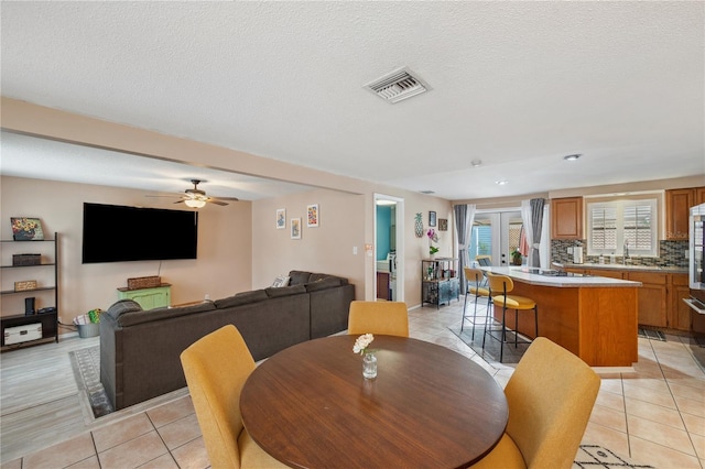 8497 Portulaca Ave, Seminole, FL 33777 - dining space with light tile patterned floors, a ceiling fan, recessed lighting, and a textured ceiling