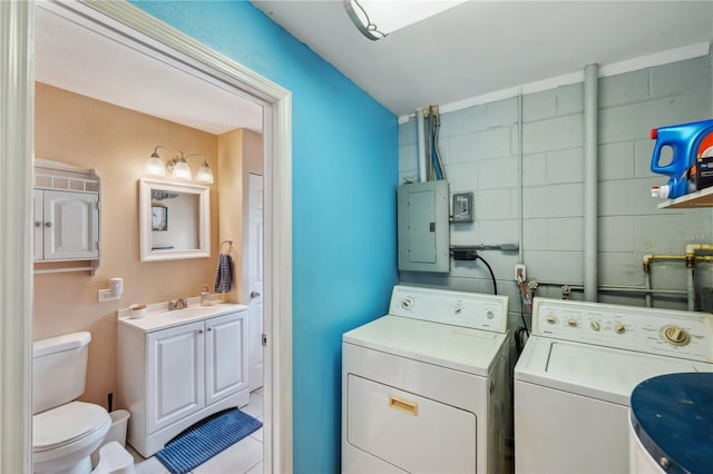 8497 Portulaca Ave, Seminole, FL 33777 - laundry area with electric panel, washing machine and dryer, and light tile patterned floors