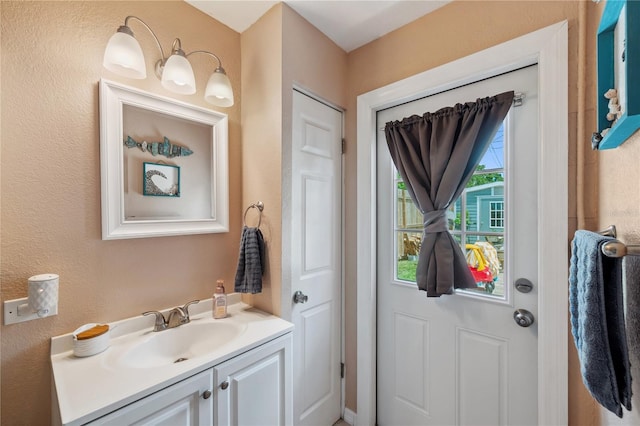 8497 Portulaca Ave, Seminole, FL 33777 - bathroom featuring vanity and a textured wall