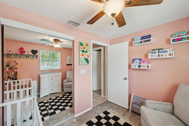 8497 Portulaca Ave, Seminole, FL 33777 - bedroom featuring a closet, a ceiling fan, and a textured ceiling