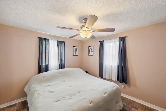 8497 Portulaca Ave, Seminole, FL 33777 - bedroom with a textured ceiling, baseboards, and ceiling fan