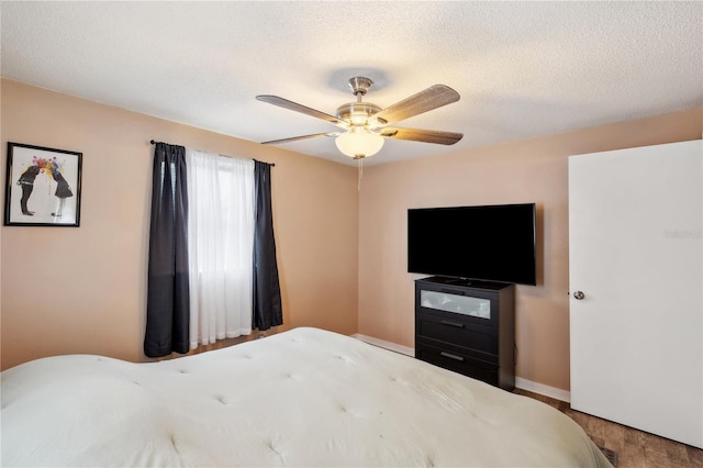 8497 Portulaca Ave, Seminole, FL 33777 - bedroom with ceiling fan, wood finished floors, a textured ceiling, and baseboards