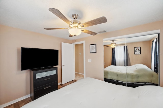 8497 Portulaca Ave, Seminole, FL 33777 - bedroom with a closet, a ceiling fan, wood finished floors, and baseboards