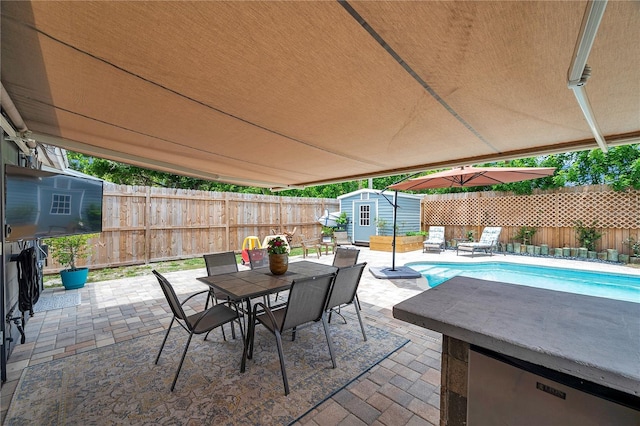 8497 Portulaca Ave, Seminole, FL 33777 - view of patio / terrace with a shed, outdoor dining area, an outdoor structure, and a fenced backyard