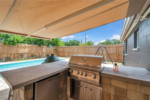 8497 Portulaca Ave, Seminole, FL 33777 - view of patio with exterior kitchen, a fenced backyard, and a grill