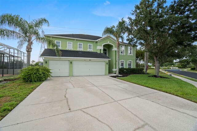 2832 Brinley Dr, New Port Richey, FL 34655 - view of front of home featuring stucco siding, a garage, driveway, and a front lawn