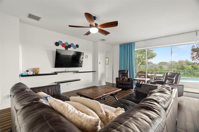 2832 Brinley Dr, New Port Richey, FL 34655 - living room featuring a ceiling fan, wood finished floors, and baseboards