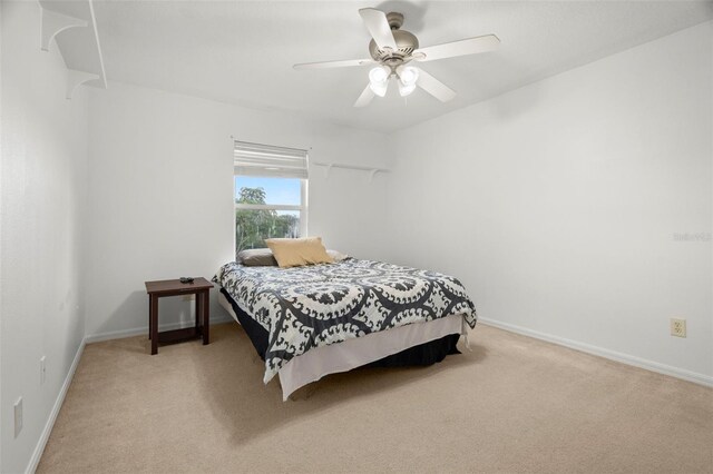 2832 Brinley Dr, New Port Richey, FL 34655 - bedroom featuring light carpet, baseboards, and ceiling fan
