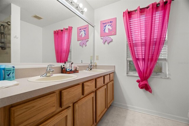 2832 Brinley Dr, New Port Richey, FL 34655 - bathroom with double vanity, baseboards, and a shower