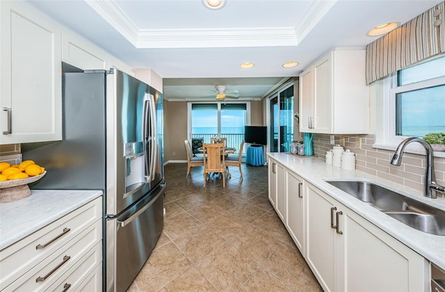 1600 Gulf Blvd Unit 514, Clearwater Beach, FL 33767 - kitchen with a sink, ornamental molding, a raised ceiling, stainless steel refrigerator with ice dispenser, and backsplash