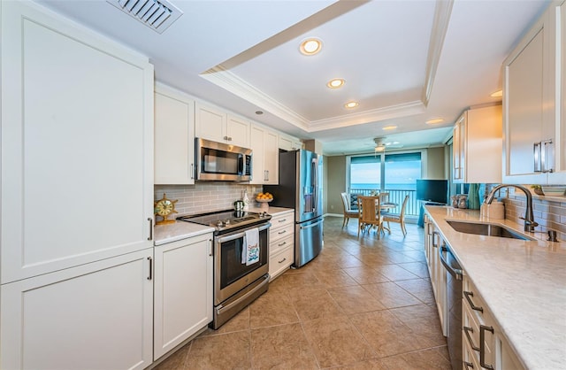 1600 Gulf Blvd Unit 514, Clearwater Beach, FL 33767 - kitchen featuring stainless steel appliances, a sink, a raised ceiling, tasteful backsplash, and recessed lighting