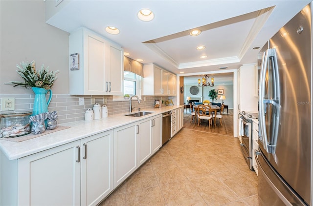 1600 Gulf Blvd Unit 514, Clearwater Beach, FL 33767 - kitchen with appliances with stainless steel finishes, a sink, a raised ceiling, tasteful backsplash, and ornamental molding