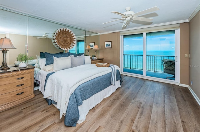 1600 Gulf Blvd Unit 514, Clearwater Beach, FL 33767 - bedroom with access to exterior, wood finished floors, ornamental molding, a ceiling fan, and baseboards