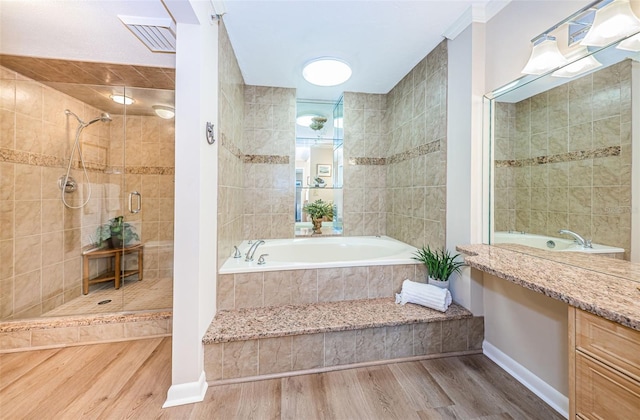 1600 Gulf Blvd Unit 514, Clearwater Beach, FL 33767 - bathroom featuring a shower stall, wood finished floors, a bath, baseboards, and vanity
