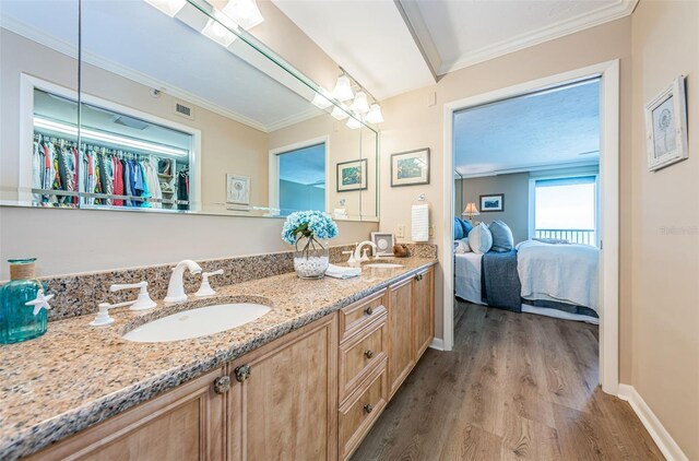 1600 Gulf Blvd Unit 514, Clearwater Beach, FL 33767 - bathroom featuring wood finished floors, baseboards, ensuite bath, double vanity, and ornamental molding