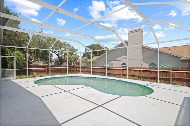 view of pool with a patio area, a fenced backyard, and a lanai