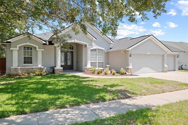 single story home featuring french doors, stone siding, stucco siding, and a garage