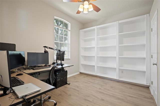 office space featuring light wood-type flooring, ceiling fan, and baseboards