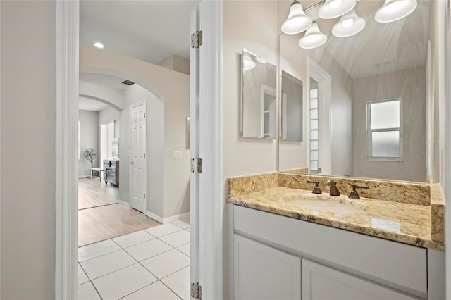 bathroom with tile patterned flooring, vanity, and baseboards