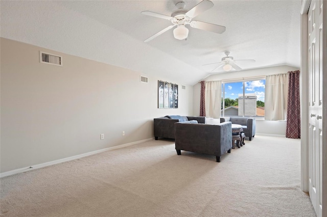 living room with light carpet, vaulted ceiling, baseboards, a ceiling fan, and a textured ceiling