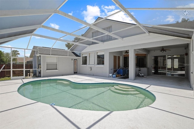 view of swimming pool with a ceiling fan, a patio area, and a lanai