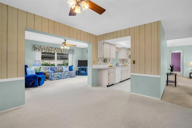 2113 Malcolm Dr, Palm Harbor, FL 34684 - kitchen with dishwasher, a ceiling fan, light colored carpet, open floor plan, and wood walls