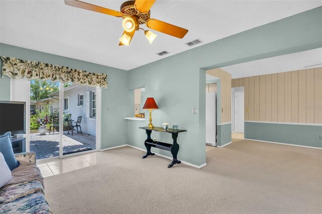 2113 Malcolm Dr, Palm Harbor, FL 34684 - carpeted living area featuring a ceiling fan and baseboards