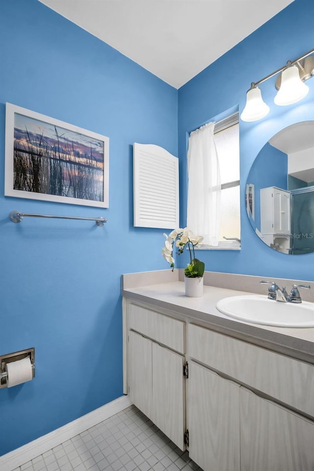 2113 Malcolm Dr, Palm Harbor, FL 34684 - bathroom with vanity, tile patterned flooring, and a shower with shower door