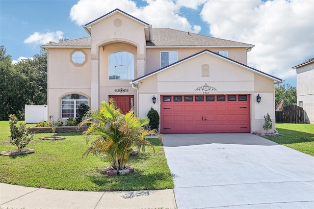 4422 Evergreen Forest Loop, Kissimmee, FL 34758 - view of front of house featuring a garage, driveway, and stucco siding