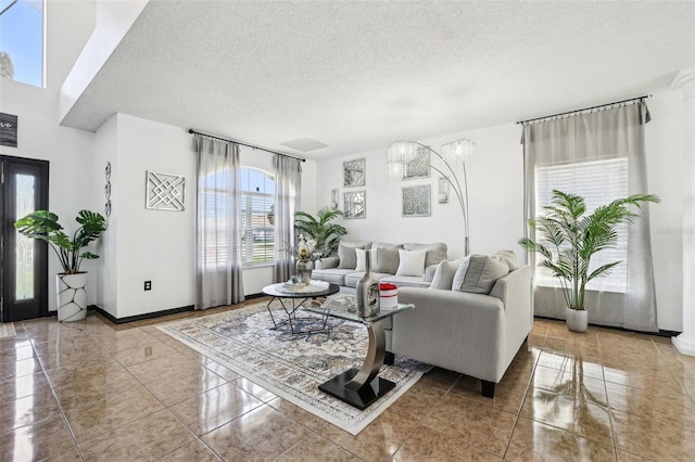 4422 Evergreen Forest Loop, Kissimmee, FL 34758 - living room with a textured ceiling, tile patterned floors, and baseboards