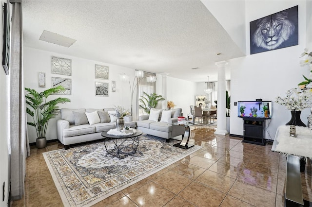 4422 Evergreen Forest Loop, Kissimmee, FL 34758 - living room featuring decorative columns, tile patterned floors, a textured ceiling, and baseboards