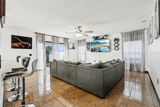 4422 Evergreen Forest Loop, Kissimmee, FL 34758 - tiled living area with a ceiling fan and a textured ceiling