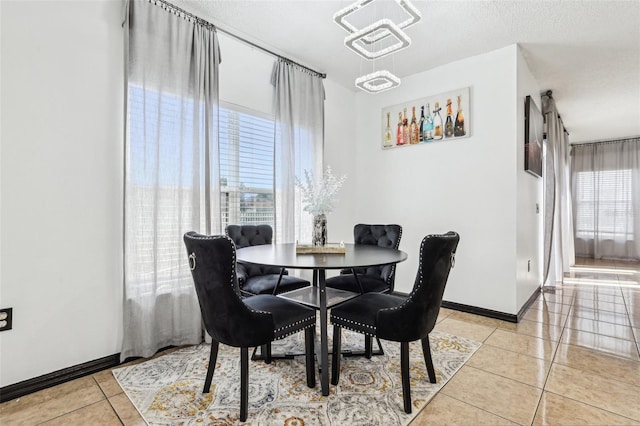 4422 Evergreen Forest Loop, Kissimmee, FL 34758 - dining area featuring light tile patterned floors, baseboards, and a textured ceiling
