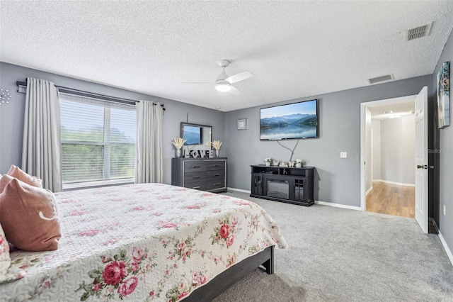 4422 Evergreen Forest Loop, Kissimmee, FL 34758 - bedroom featuring a textured ceiling, carpet flooring, a ceiling fan, and baseboards