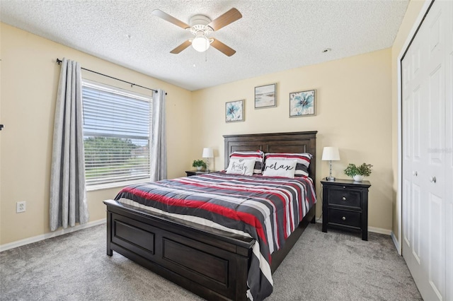 4422 Evergreen Forest Loop, Kissimmee, FL 34758 - carpeted bedroom featuring a textured ceiling, a closet, baseboards, and a ceiling fan