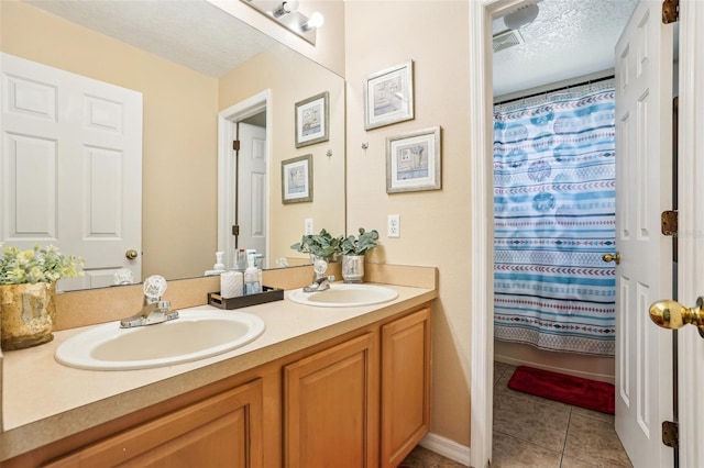 4422 Evergreen Forest Loop, Kissimmee, FL 34758 - bathroom featuring tile patterned floors, double vanity, a textured ceiling, and a shower with curtain